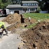 Plumbing crew performing a residential sewer line replacement excavation in Clifton Park, NY