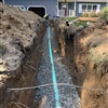 Sewer line replacement trench showing new underground plumbing installation at a Clifton Park residence