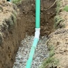 New PVC sewer line installed in an excavated trench during a sewer replacement project in Clifton Park